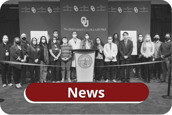 Black and white image of students, faculty, and staff wearing face masks gathered to celebrate a ribbon cutting. Title on image says "News".